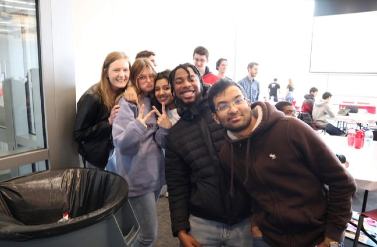 Group of 5 students at LaunchpadOSU and two holding up the peace sign