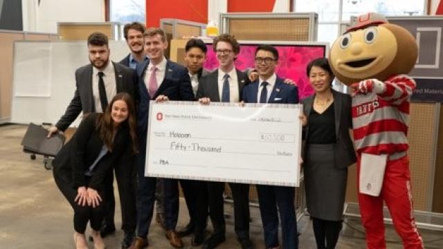 Image of full group of Holocron with Grace Wang and Brutus with check at Pitch Finale.