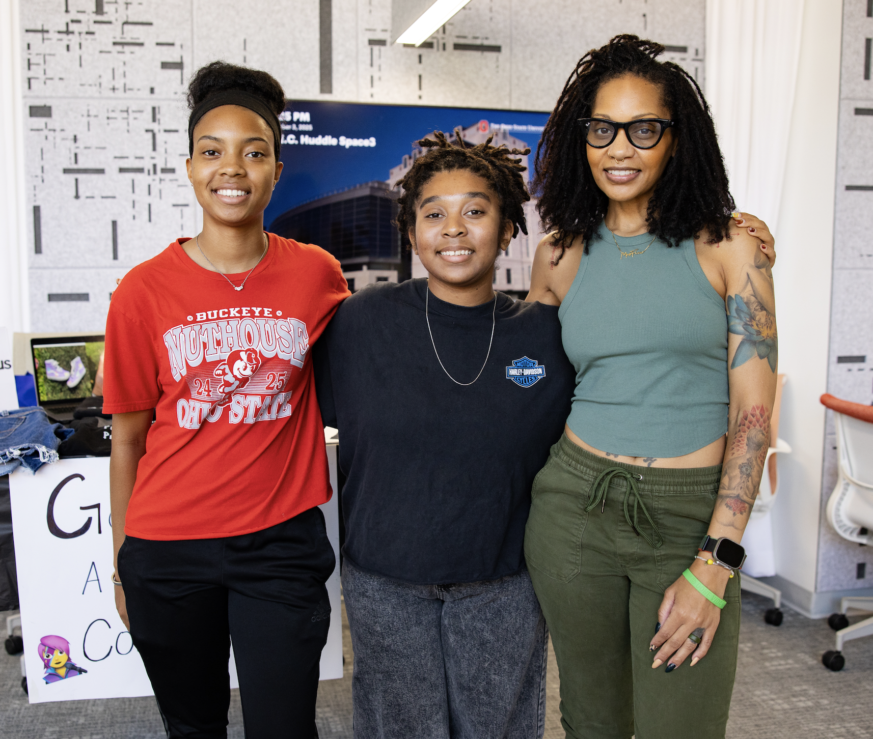 Olivia Ratchford, center, founder of Ondreaus, talks with friends and family during the Buckeye Made Market at the Student Entrepreneurs’ Center at The Ohio State University.